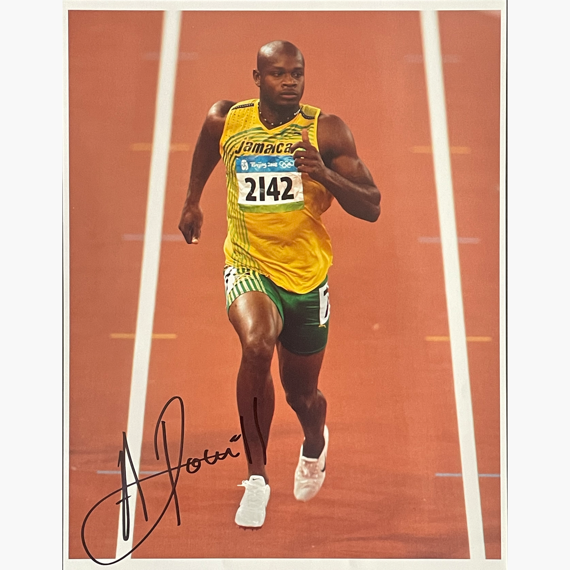 Asafa Powell – Signed 24.2cm x 18.7cm Colour Action Photo