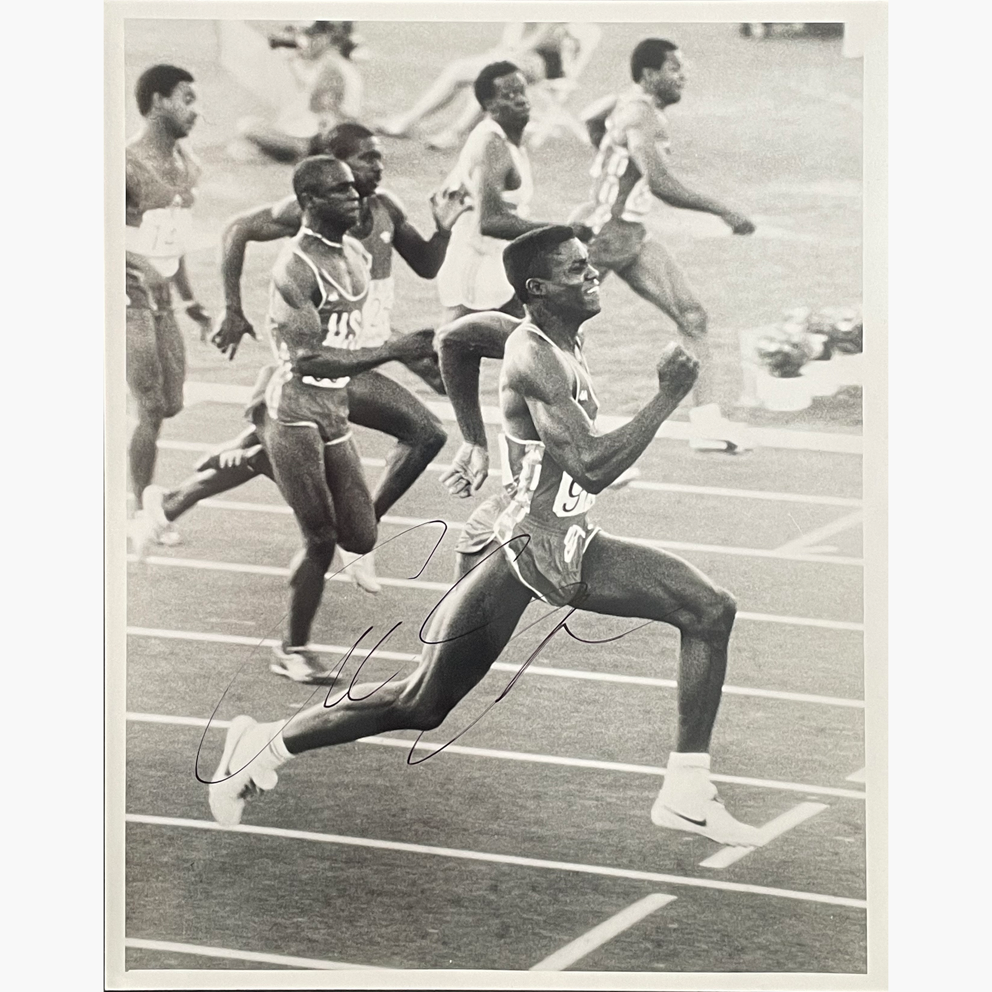 Carl Lewis – Signed 25.3cm x 20cm Black & White Action Press Photo